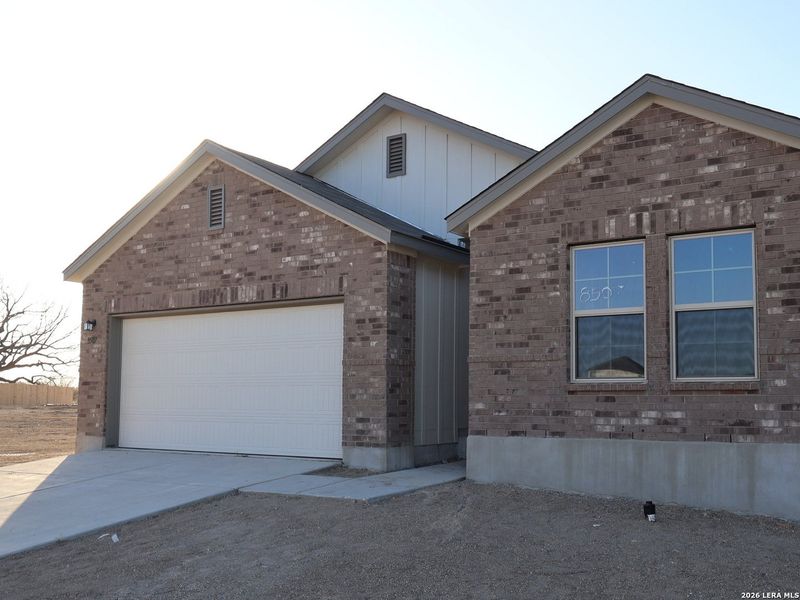 Front exterior of a new home in Cinco Lakes, San Antonio, TX, highlighting curb appeal (Image 25).