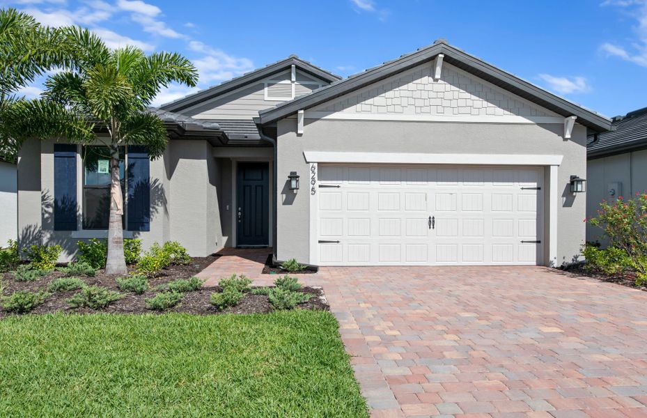 Front exterior of a new home in Del Webb Naples, Immokalee, FL, highlighting curb appeal (Image 2).