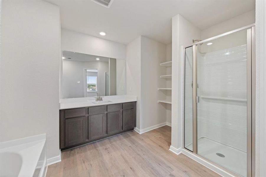 Bathroom with vanity, wood-type flooring, and separate shower and tub