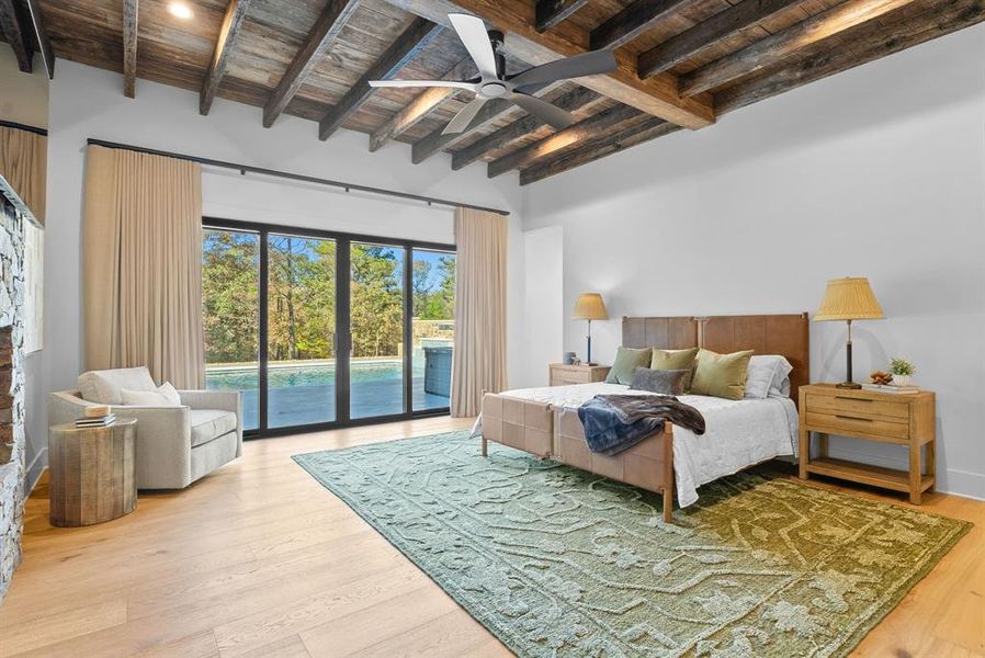 Bedroom featuring a wooden ceiling with exposed beams, access to exterior, light wood-style flooring, and a ceiling fan