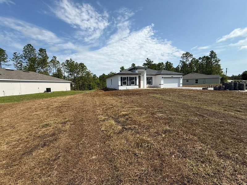 Front exterior of a new home in , Ocala, FL, highlighting curb appeal (Image 1).
