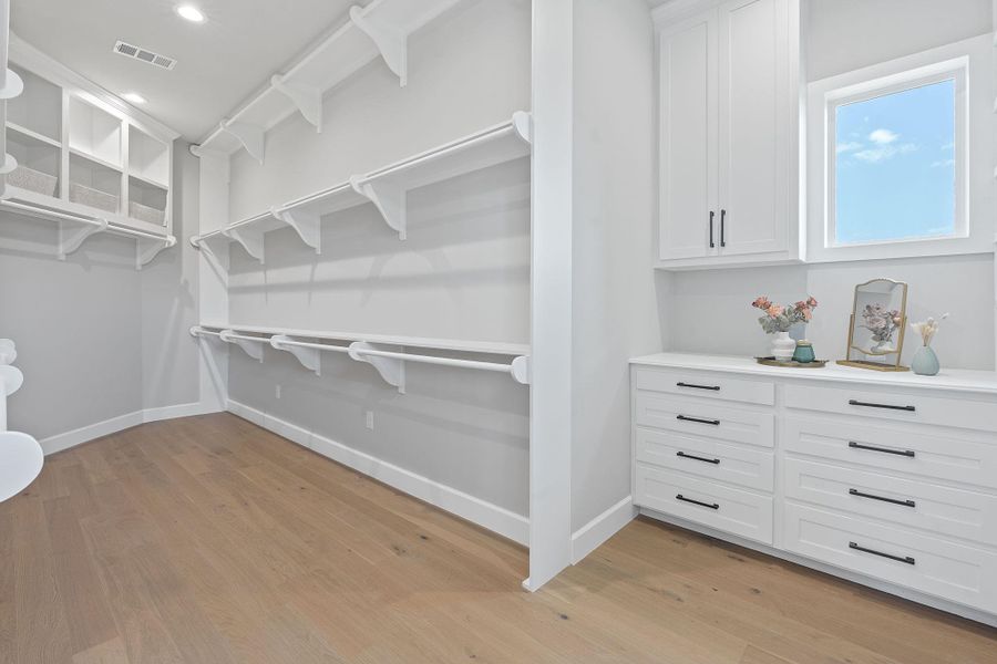 Spacious closet with light wood-style floors