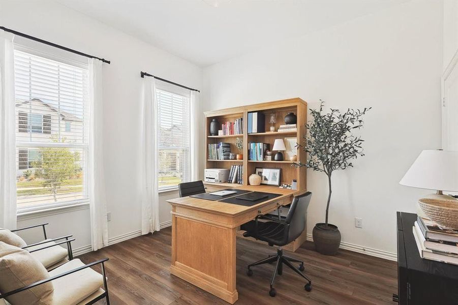 Office with dark hardwood / wood-style floors and plenty of natural light