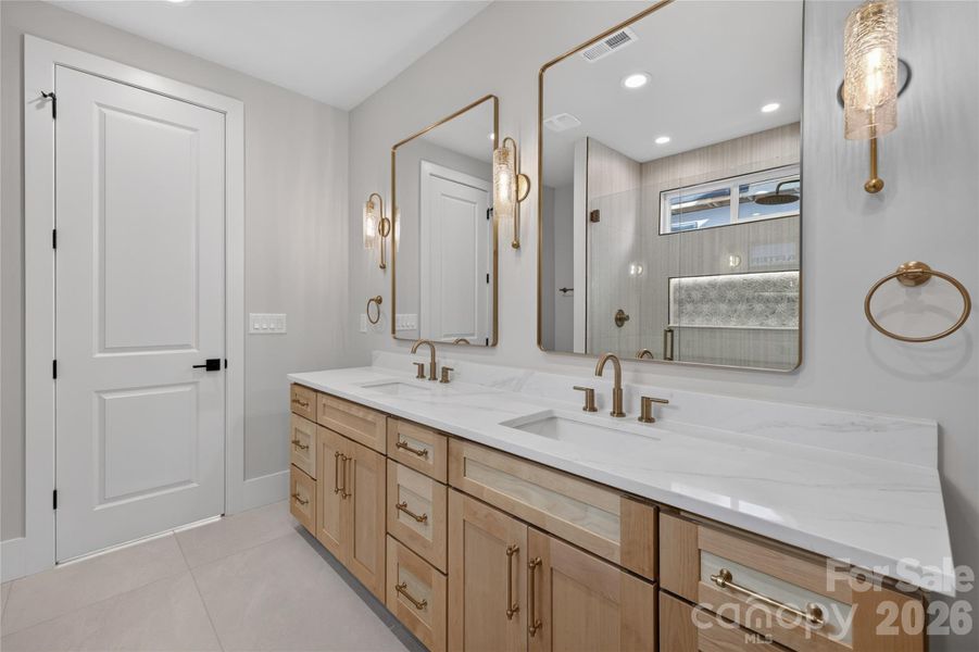 Jack & Jill bath, quartz countertops, maple cabinetry, porcelin floors, gorgeous champagne gold sconces/fixtures