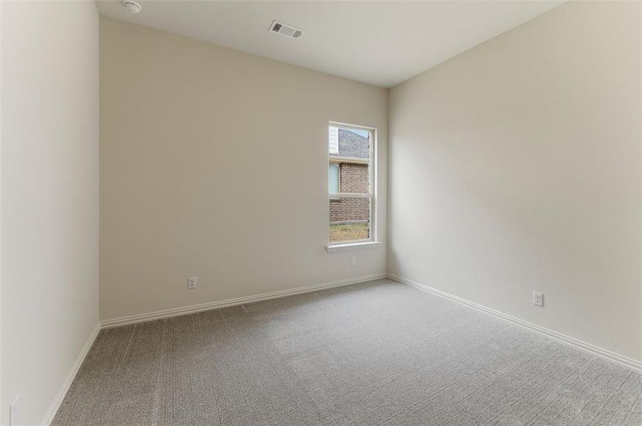 Spare room featuring light colored carpet and baseboards