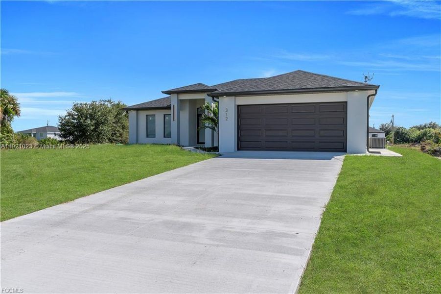 Front exterior of a new home in , Lehigh Acres, FL, highlighting curb appeal (Image 26). Front exterior of a new home in , Lehigh Acres, FL, highlighting curb appeal (Image 26).