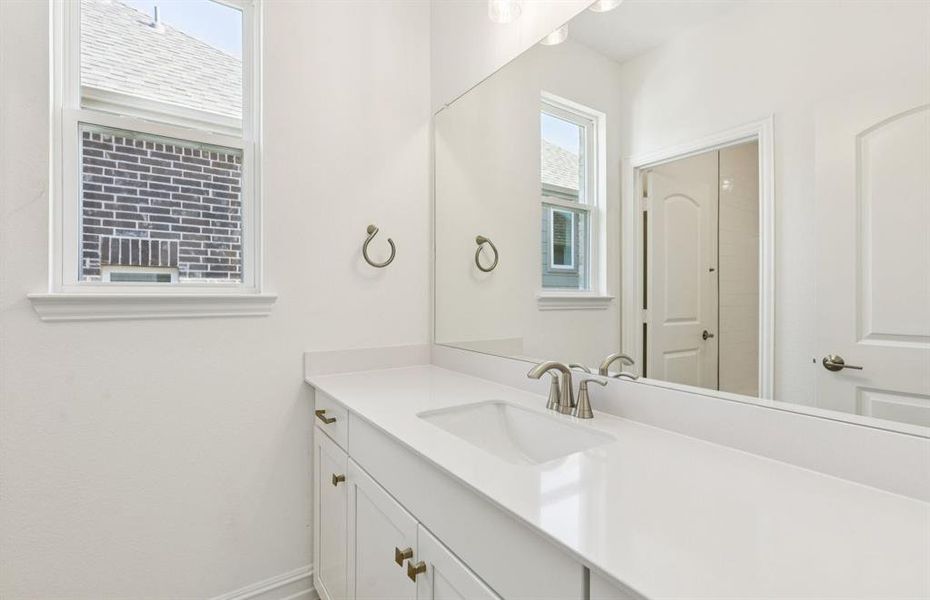 Secondary bathroom with a window providing natural light