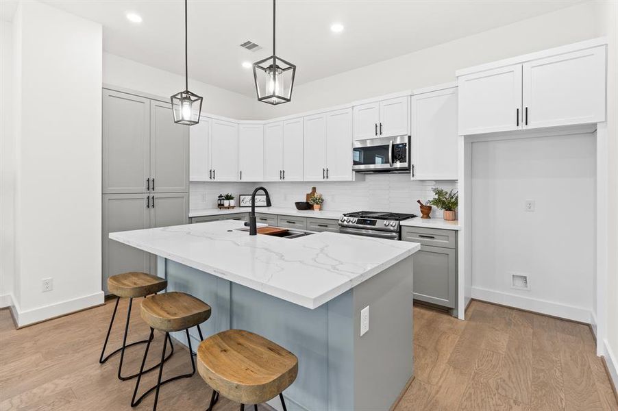 Soft close cabinets and drawers with an quartz island countertop and counterspace gives a timeless look.