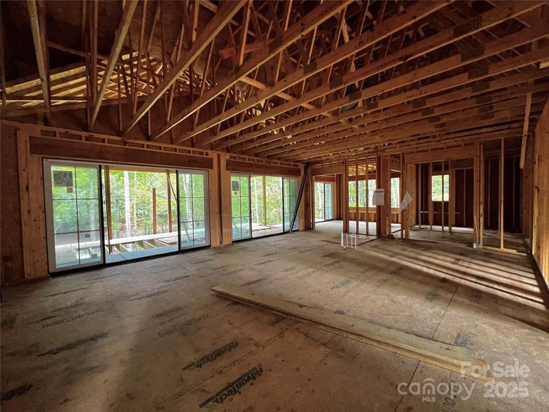The living room opens up to a chef's kitchen with two oversized sliders seamlessly connecting out to an oversized screen porch The living room opens up to a chef's kitchen with two oversized sliders seamlessly connecting out to an oversized screen porch