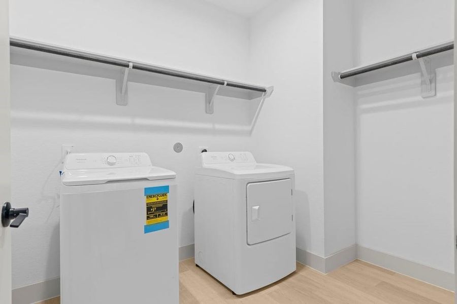A laundry room featuring a washer and dryer, neatly arranged with ample space for laundry tasks and storage. A laundry room featuring a washer and dryer, neatly arranged with ample space for laundry tasks and storage.