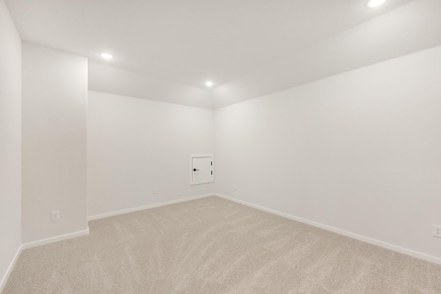 Empty room with white walls, beige carpet, recessed lighting, and a small access panel door Empty room with white walls, beige carpet, recessed lighting, and a small access panel door