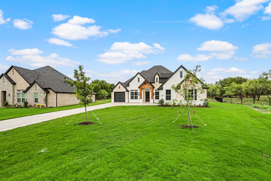 Front exterior of a new home in Rolling Creek Ranch, Aledo, TX, highlighting curb appeal (Image 2). Front exterior of a new home in Rolling Creek Ranch, Aledo, TX, highlighting curb appeal (Image 2).