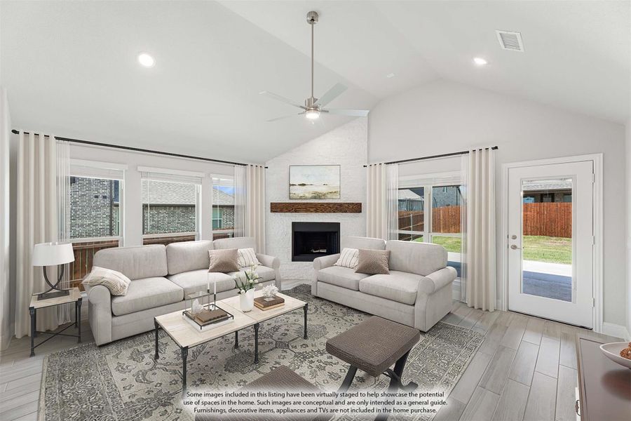 Living room with vaulted ceiling, stone fireplace, ceiling fan, and backyard access door