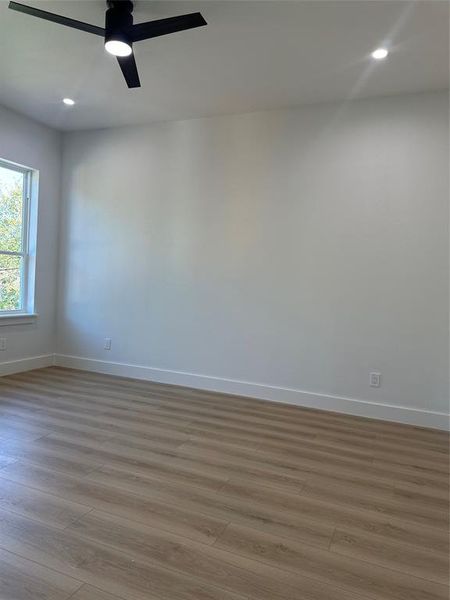 Spare room featuring ceiling fan and light wood-type flooring