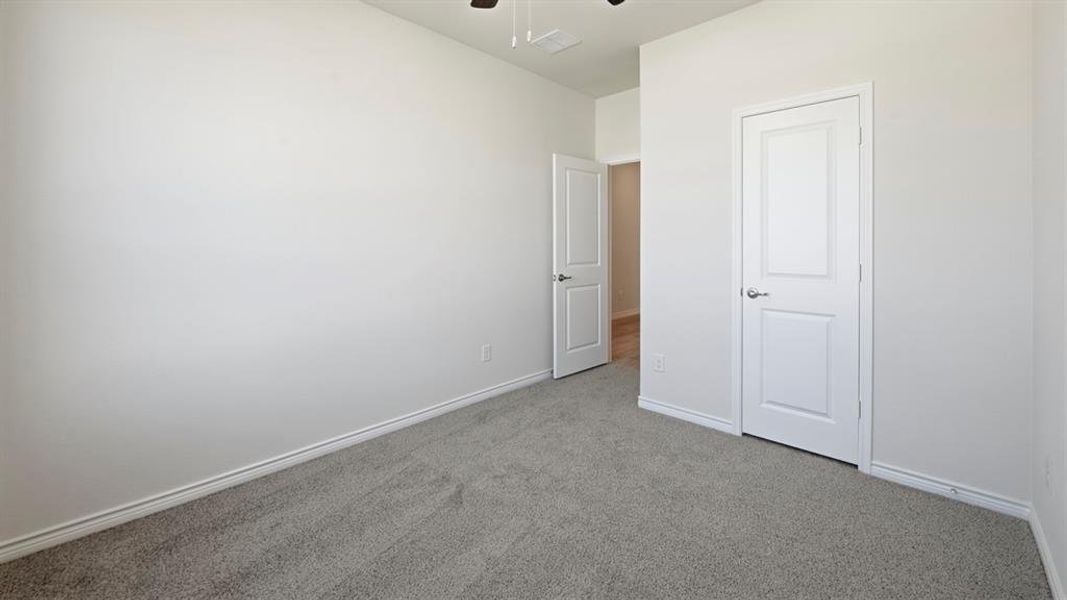 Unfurnished bedroom featuring carpet floors and a ceiling fan