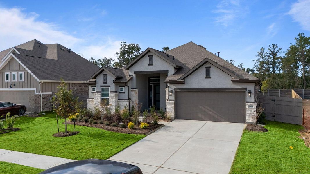 Front exterior of a new home in Artavia, Conroe, TX, highlighting curb appeal (Image 1). Front exterior of a new home in Artavia, Conroe, TX, highlighting curb appeal (Image 1).