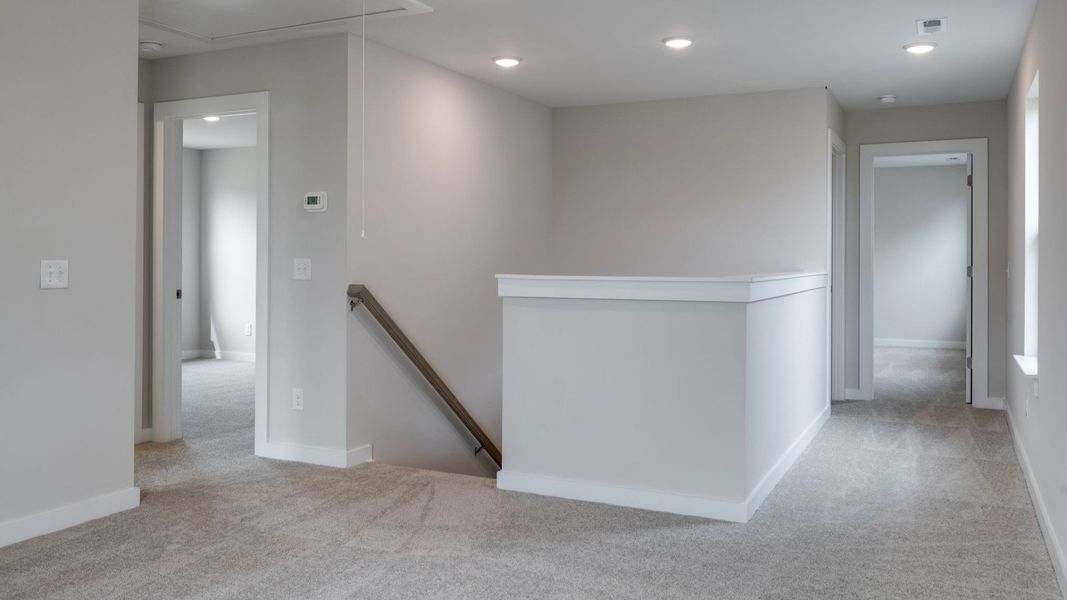 Stairway entrance to spacious second floor area