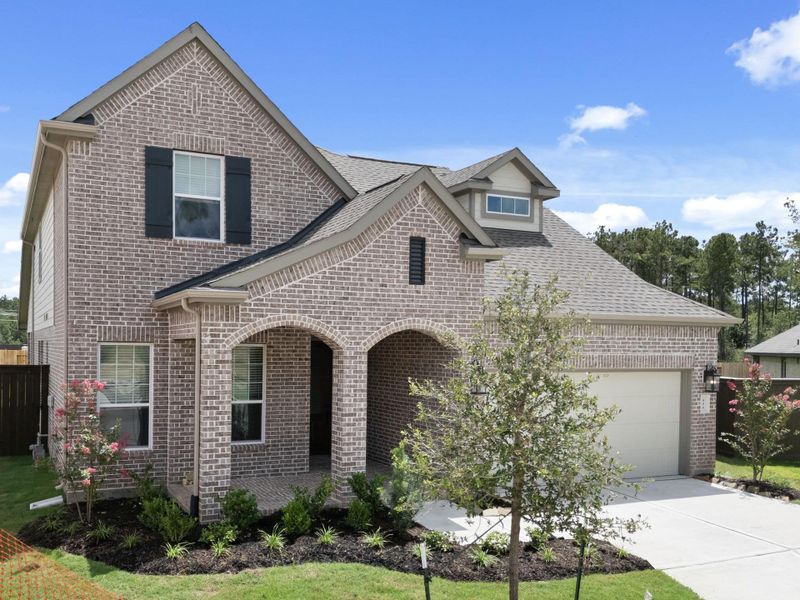 Front exterior of a new home in The Trails, New Caney, TX, highlighting curb appeal (Image 20).