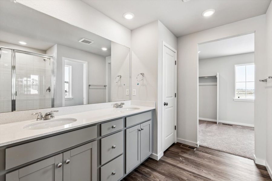 A bathroom with a large mirror.