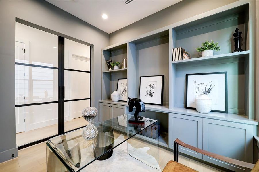 Discover productivity in style with this elegant home office, featuring sleek commercial-grade French doors for privacy and sophistication. Conveniently situated just steps away from the primary suite.