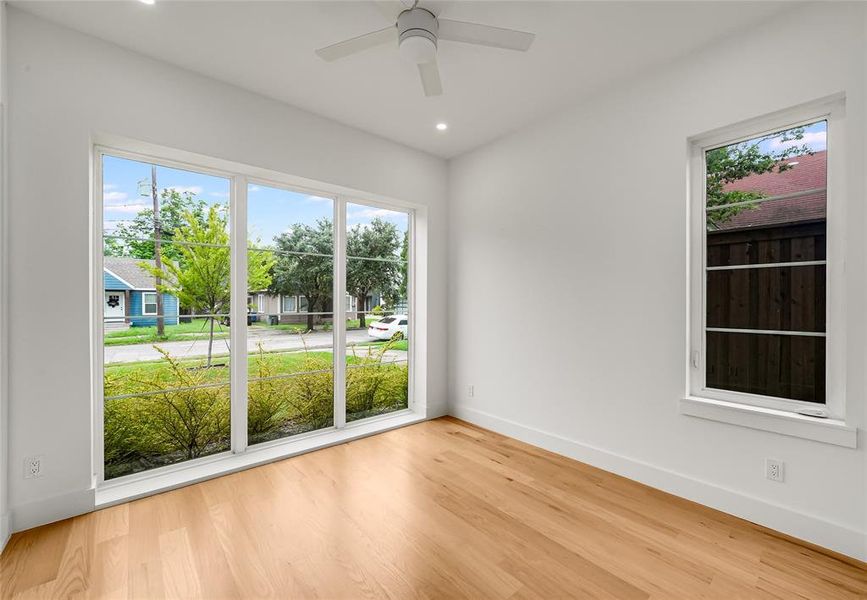 Bright interior space featuring wood-finish flooring, recessed lighting, and a ceiling fan