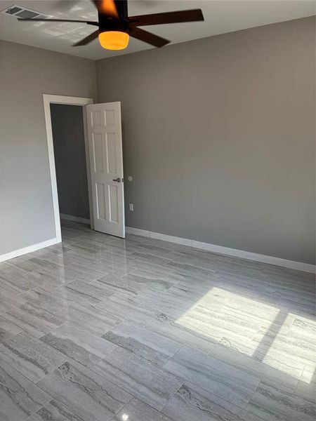 Empty room featuring a ceiling fan and baseboards Empty room featuring a ceiling fan and baseboards