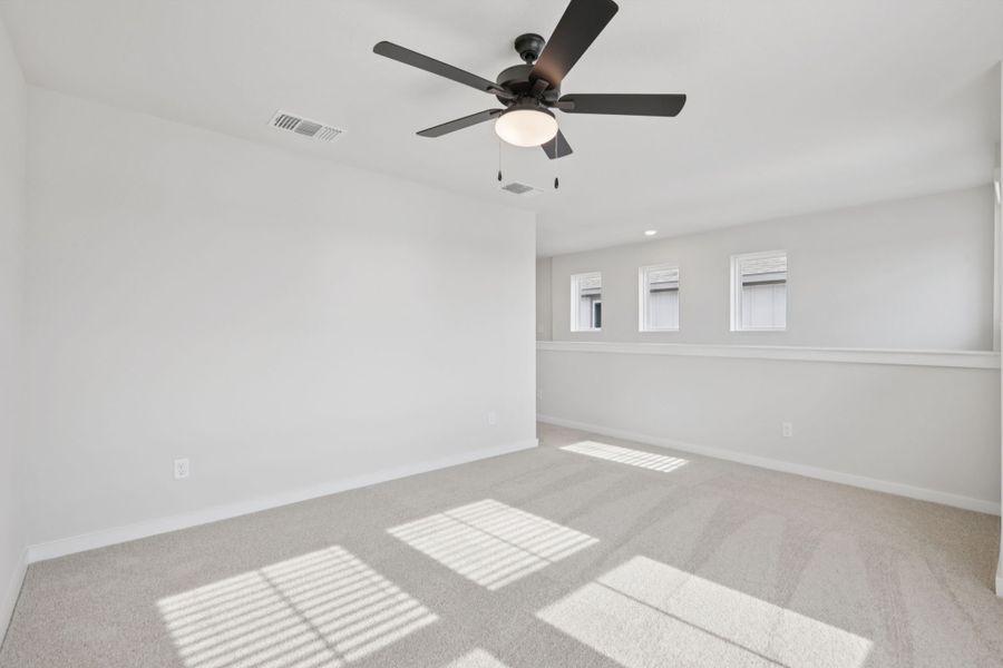 A room with a ceiling fan and a tile floor.