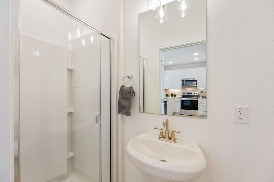 Full bath with a shower stall and recessed lighting