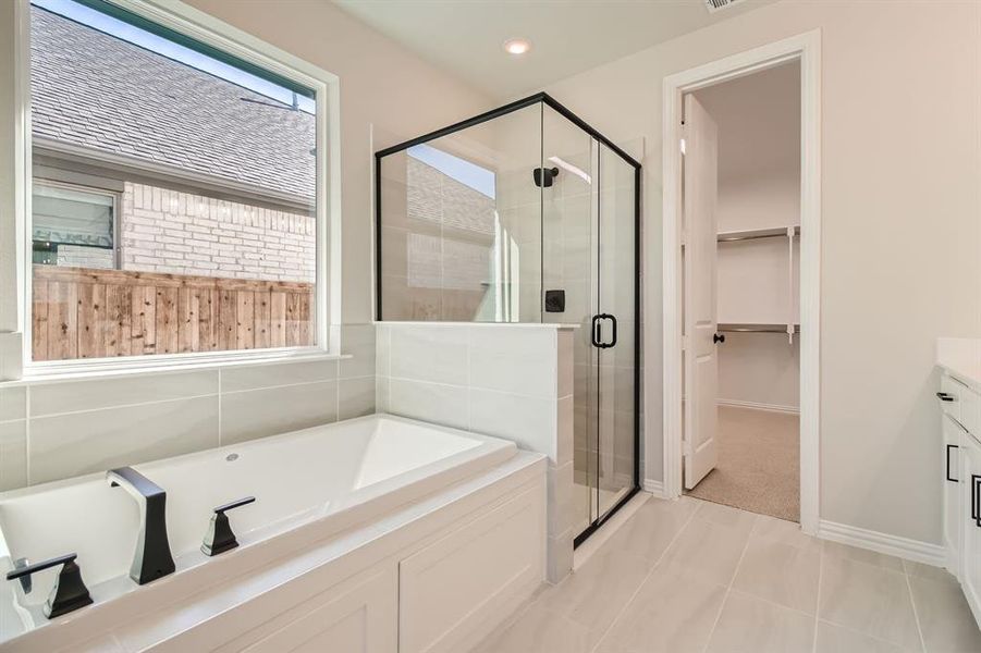 Bathroom with vanity, shower with separate bathtub, and tile patterned flooring