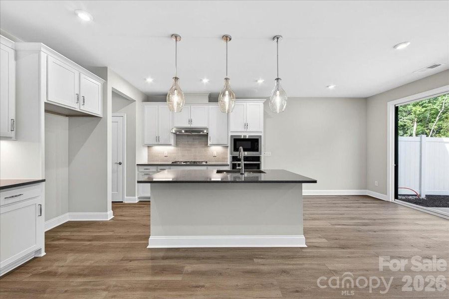 Gourmet kitchen with the outdoor living sliding door Gourmet kitchen with the outdoor living sliding door