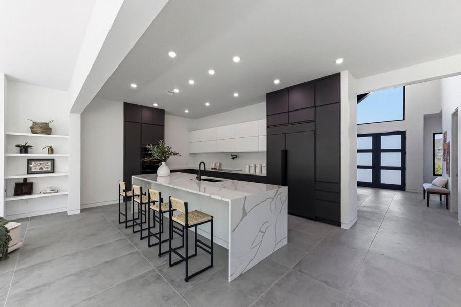 Kitchen featuring dual tone cabinets, modern cabinets, a kitchen bar, a center island with sink, and paneled built in fridge