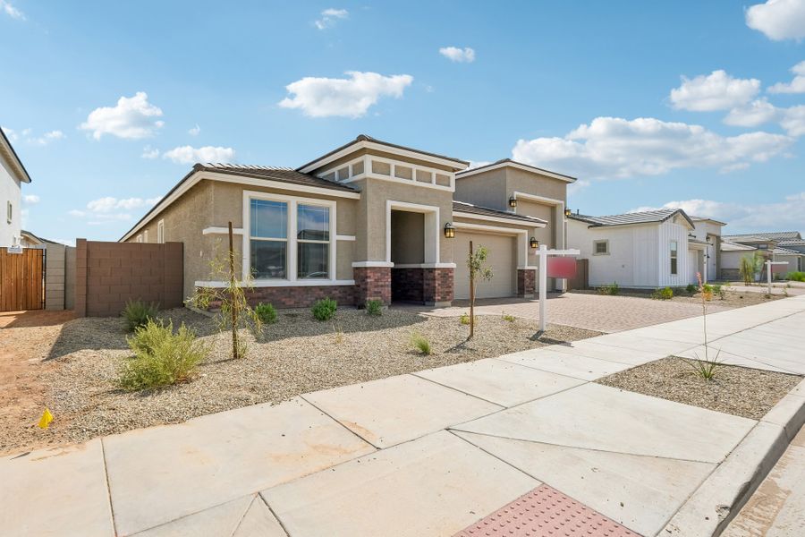 Front exterior of a new home in Artisan at Asante, Surprise, AZ, highlighting curb appeal (Image 2). Front exterior of a new home in Artisan at Asante, Surprise, AZ, highlighting curb appeal (Image 2).