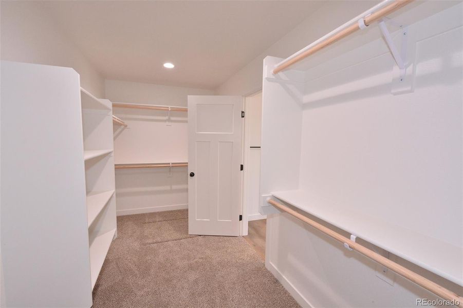 Primary bedroom walk-in closet