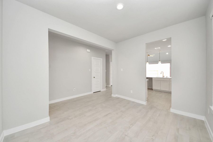 Make memories gathered around the table with your family and friends! This spacious dining room features elegant flooring, custom paint, and adjacent to family room and kitchen for open concept feel.