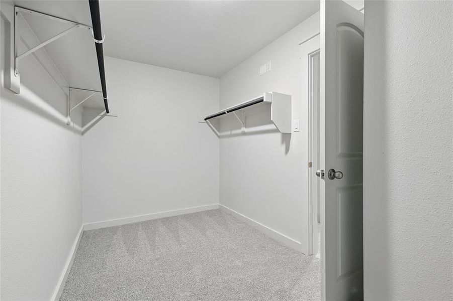 Walk in closet with light colored carpet Walk in closet with light colored carpet