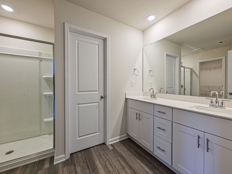 Your primary suite features a walk-in closet and a luxurious bath.