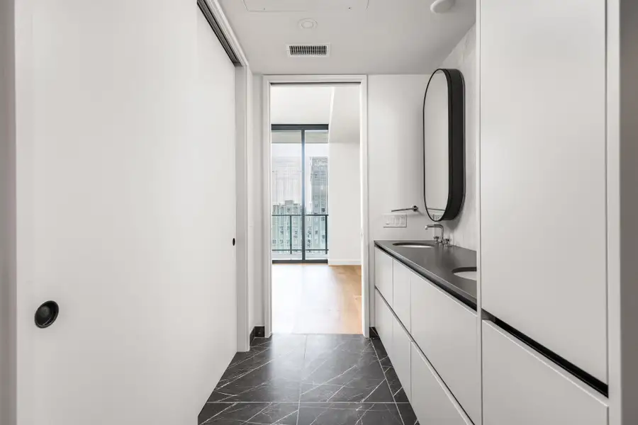 Clean lines and a striking vanity elevate this modern bathroom space.