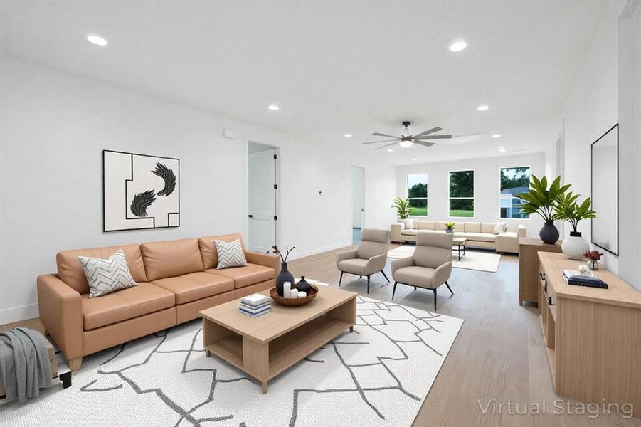 Living area with ceiling fan, light wood-style flooring, and recessed lighting