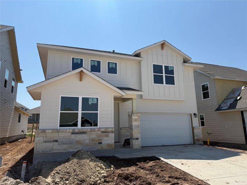Front exterior of a new home in Cannon Ranch 45s, Dripping Springs, TX, highlighting curb appeal (Image 17). Front exterior of a new home in Cannon Ranch 45s, Dripping Springs, TX, highlighting curb appeal (Image 17).