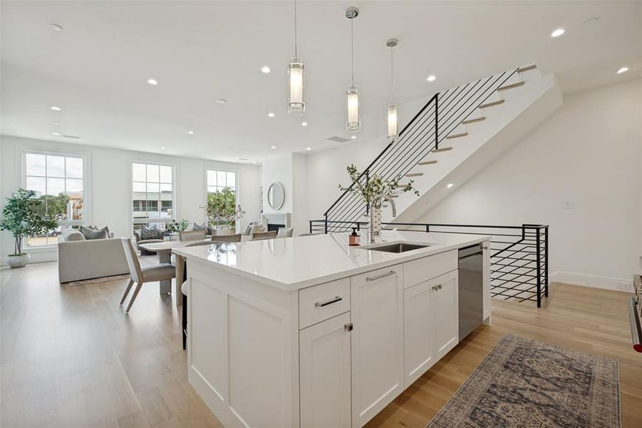 Modern kitchen island featuring integrated storage, stainless steel fixtures, and a dishwasher. Modern kitchen island featuring integrated storage, stainless steel fixtures, and a dishwasher.