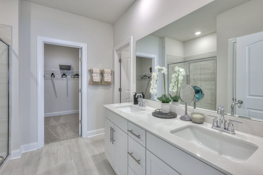 The primary bath includes dual vanity sinks and a walk-in closet.