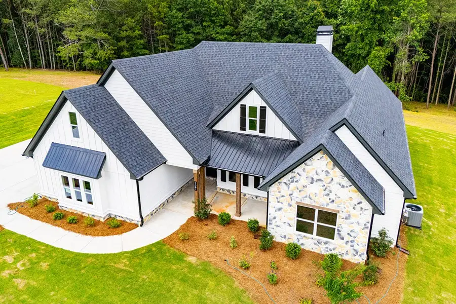 Front exterior of a new home in WOODMONT RESERVE, Roopville, GA, highlighting curb appeal (Image 47).