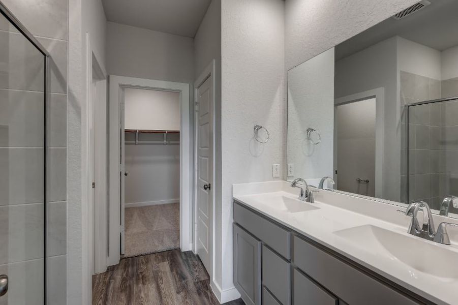 A bathroom with a sink and a mirror. A bathroom with a sink and a mirror.