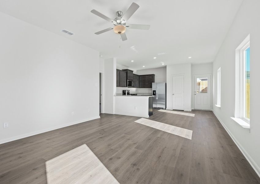 The kitchen, dining room and family room sit adjacent to one another.