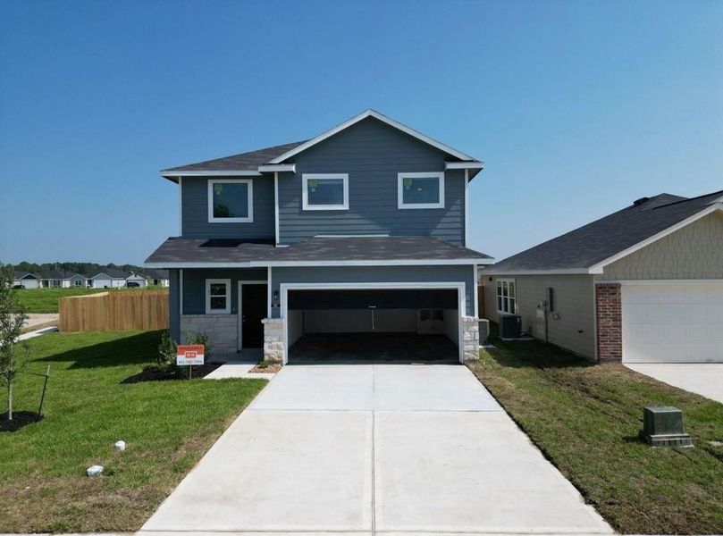 Front exterior of a new home in Villages at Westpointe, Dayton, TX, highlighting curb appeal (Image 1). Front exterior of a new home in Villages at Westpointe, Dayton, TX, highlighting curb appeal (Image 1).