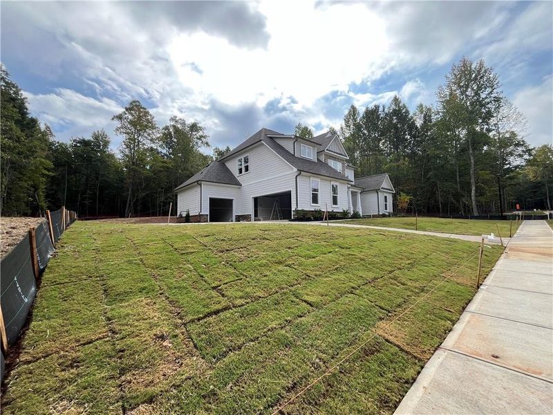 Front exterior of a new home in , Cumming, GA, highlighting curb appeal (Image 2). Front exterior of a new home in , Cumming, GA, highlighting curb appeal (Image 2).