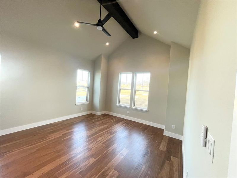 Master suite boasts high beam ceiling and is flooded with light.