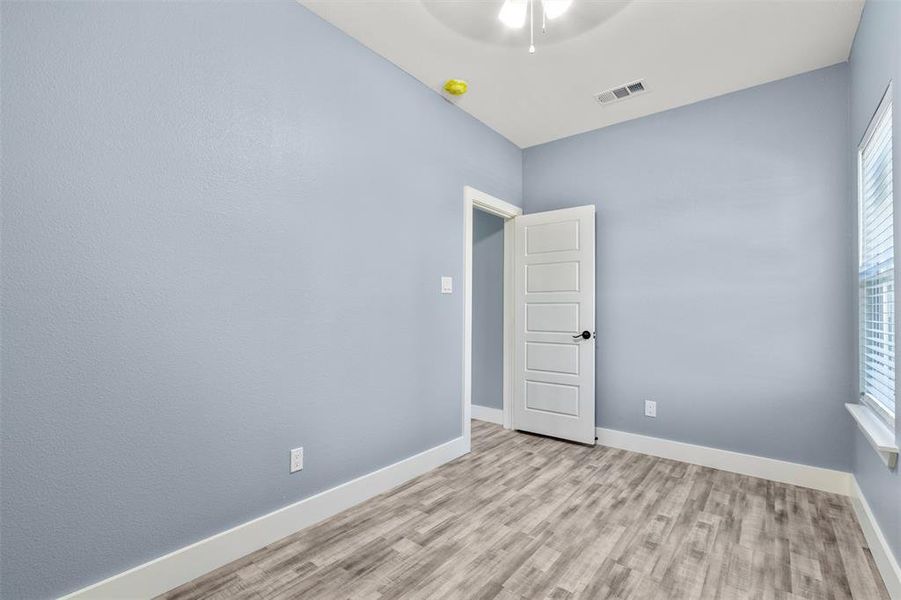 Unfurnished room with light hardwood / wood-style flooring and ceiling fan