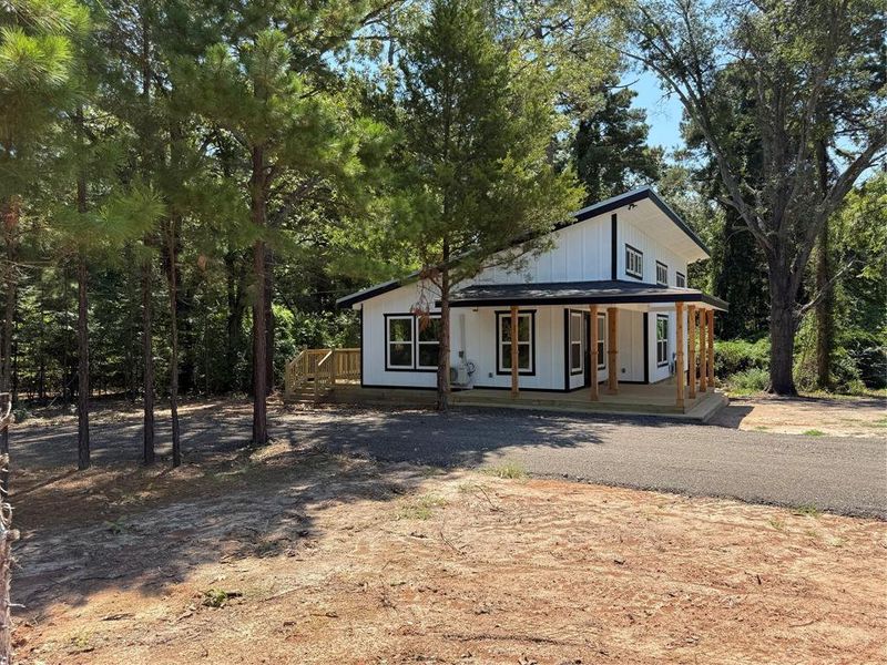 Modern inspired farmhouse with covered porch and driveway