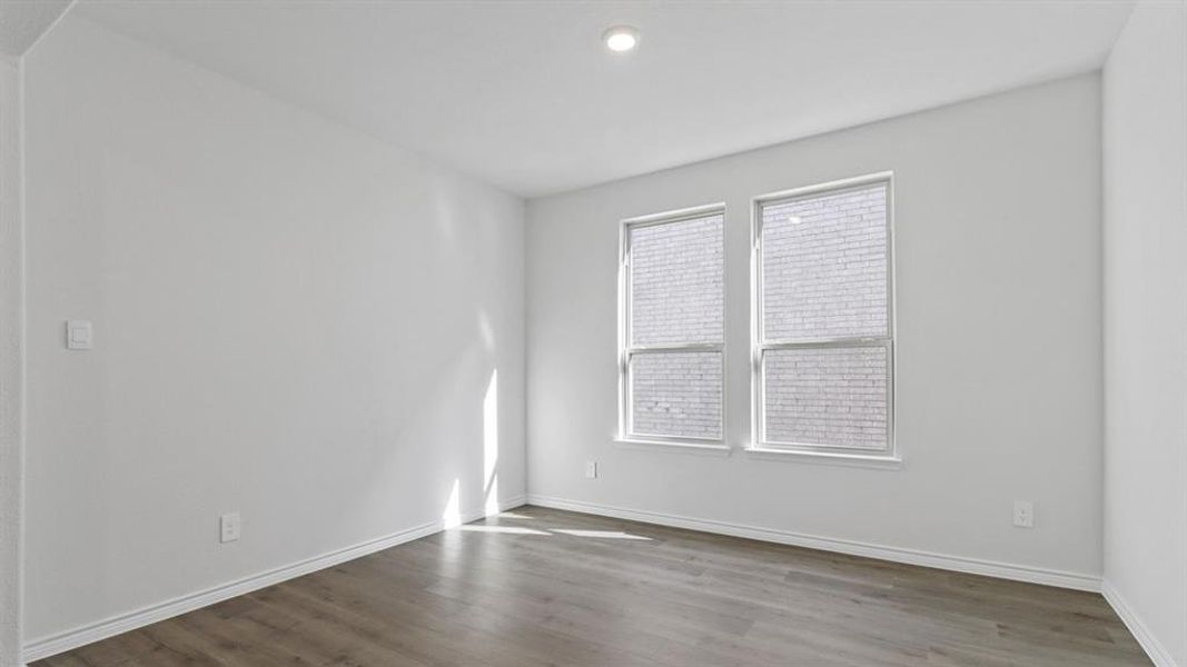 Empty room with wood finished floors and recessed lighting